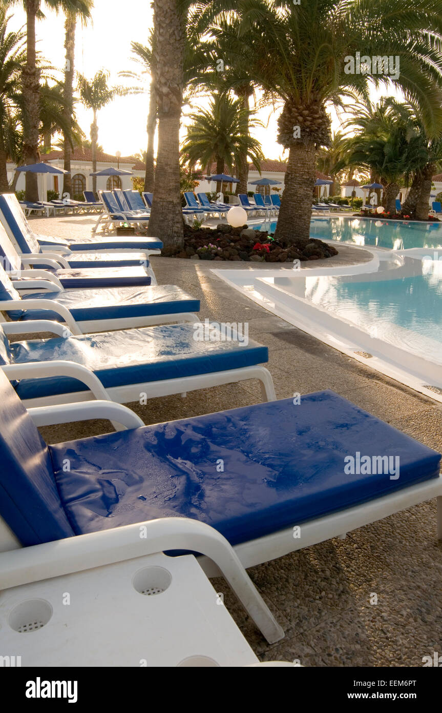 sun lounger loungers sunloungers pool poolside resort holiday holidays vacation vacations hotel hotels sunbathing sun bath bathi Stock Photo