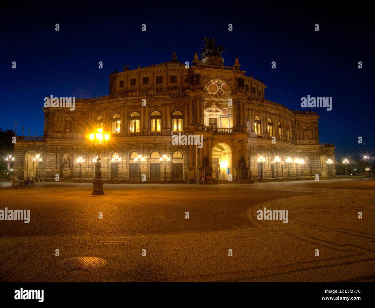 Germany, Saxony, Dresden, Illuminated Semperoper and empty square Stock Photo