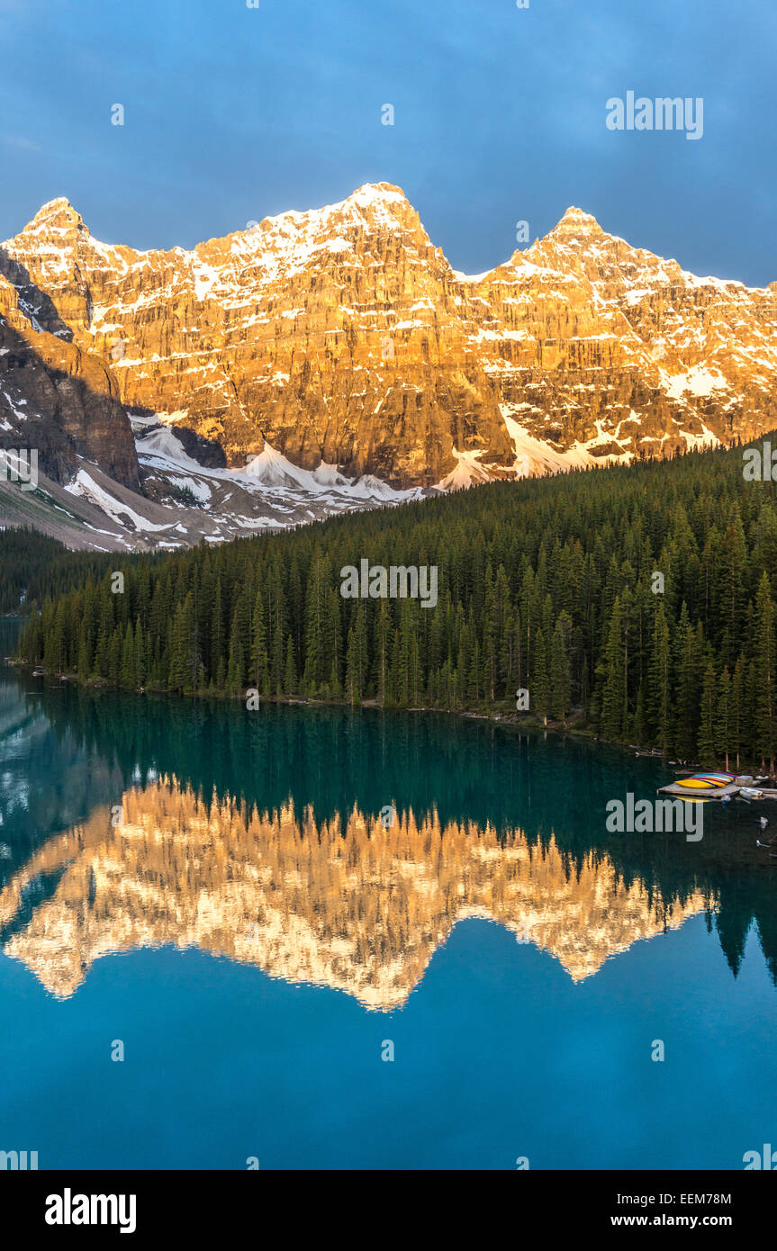 Canada, Banff National Park, Canadian Rockies, Mountains reflecting in calm lake at sunrise Stock Photo