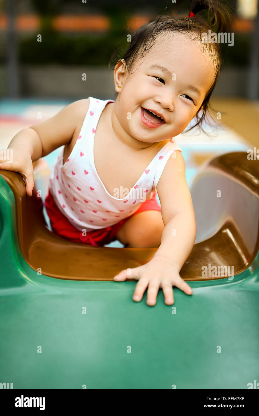 Portrait of a happy girl on a slide in an indoor playground Stock Photo ...