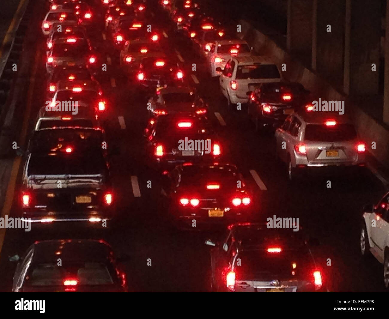 High angle view of glowing taillights of cars in traffic - Smartphone Captured Stock Image