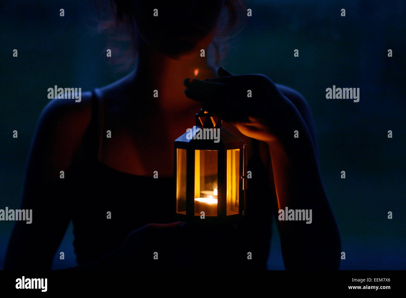 Portrait of a woman holding a glowing lantern Stock Photo - Alamy