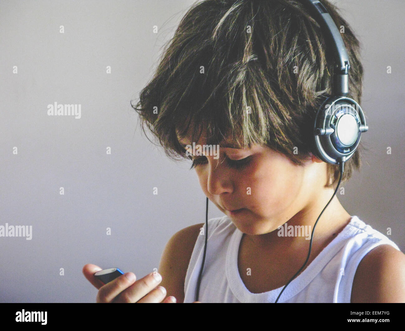Boy wearing headphones listening to music Stock Photo