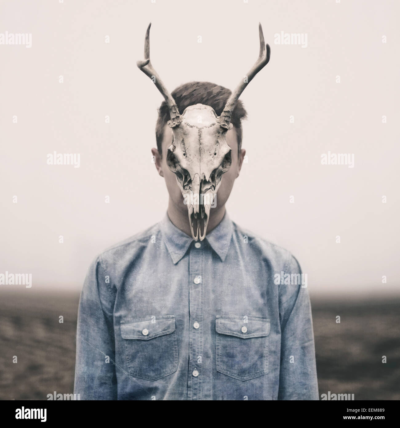 Man with animal skull on his face Stock Photo - Alamy