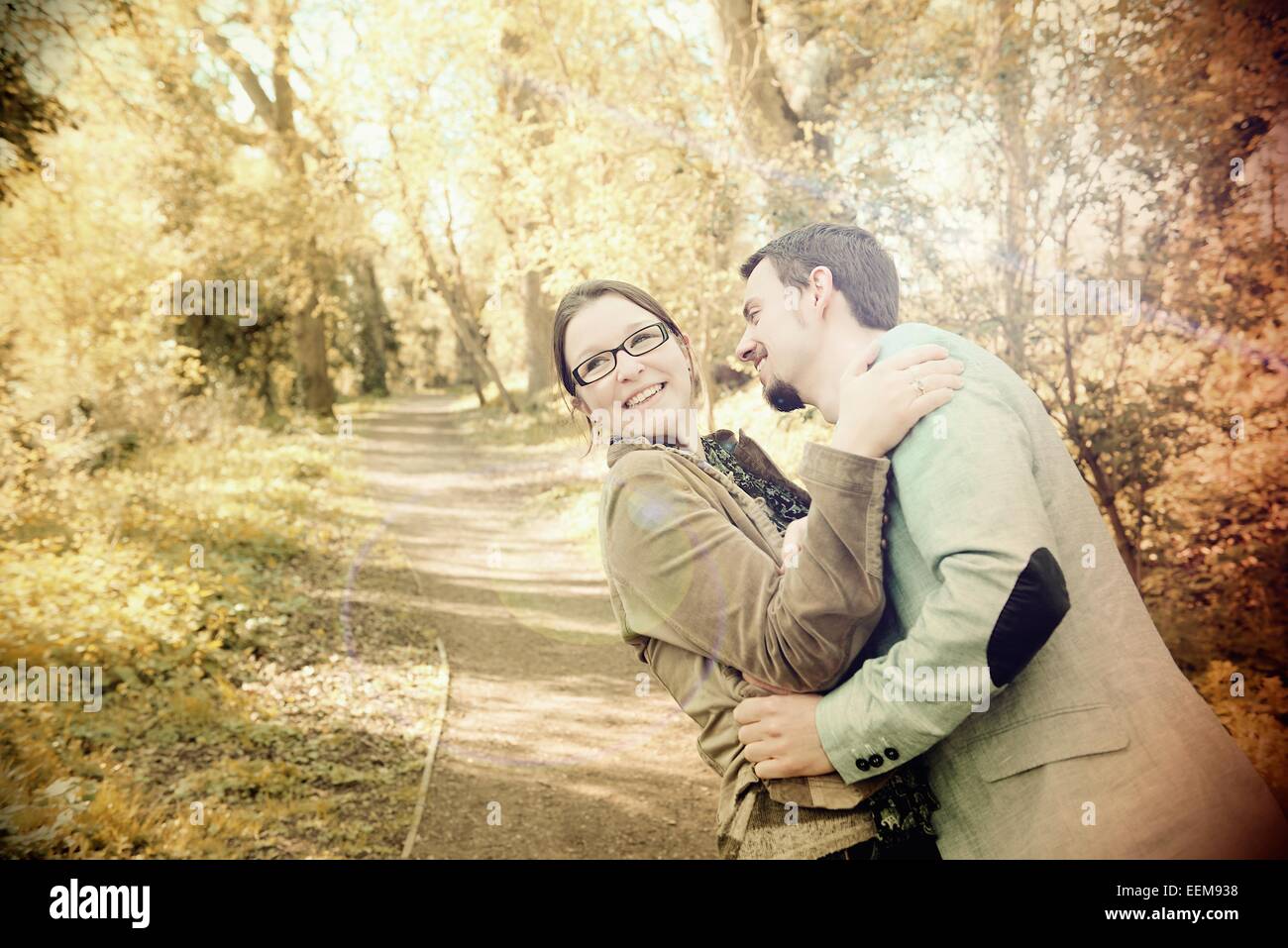 Couple hugging in rural woodland Stock Photo