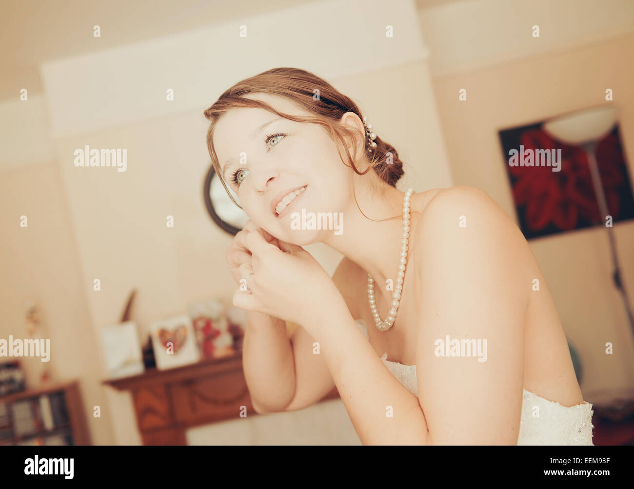 Portrait of a bride putting on her earrings Stock Photo