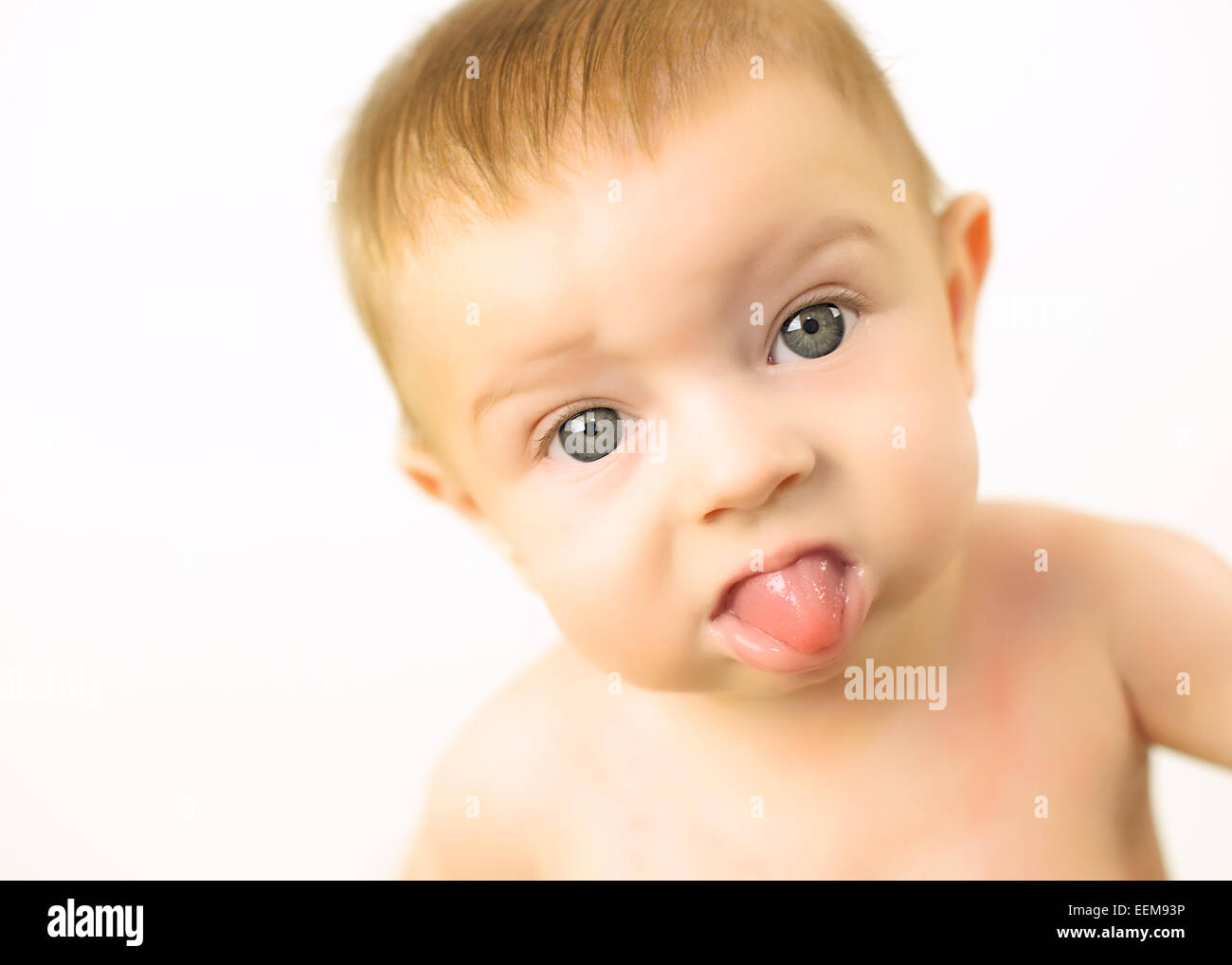 Portrait of a baby girl sticking out her tongue Stock Photo