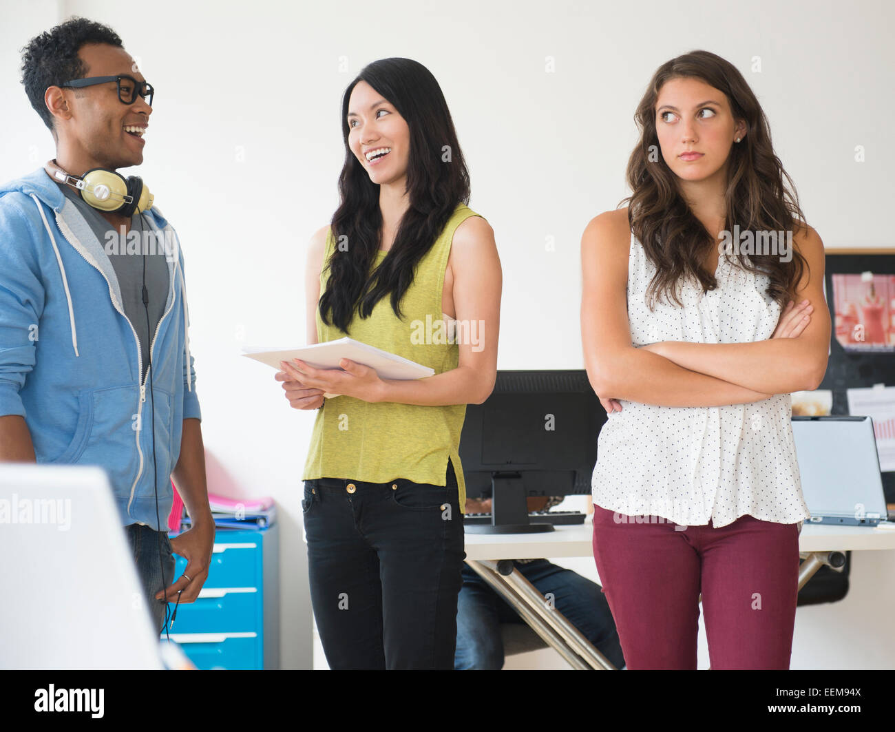 Annoyed businesswoman ignoring colleagues in office Stock Photo