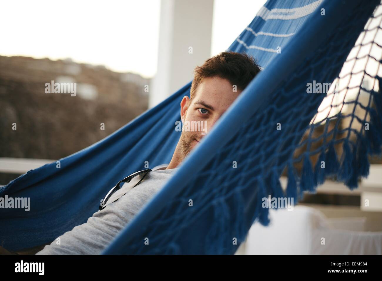 Mid adult man lying in hammock hi-res stock photography and images - Alamy