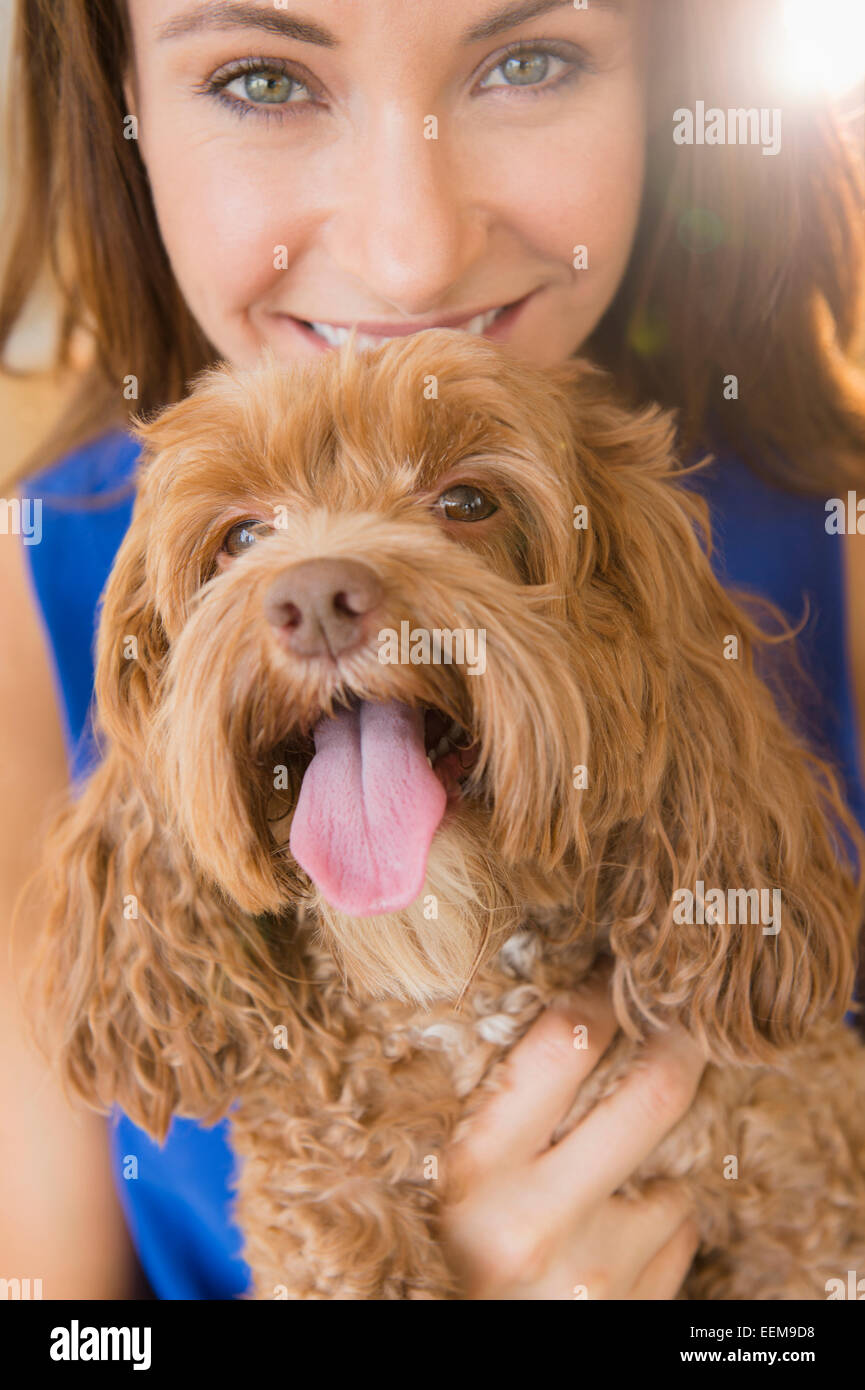 Caucasian woman holding pet dog Stock Photo