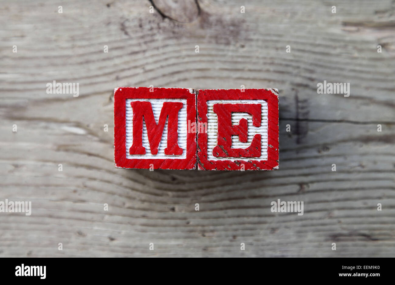 It's a photo top view of wood blocks or wood cubes combined together to create the word ME Stock Photo