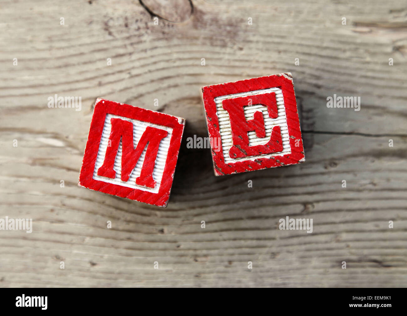 It's a photo top view of wood blocks or wood cubes combined together to create the word Me Stock Photo