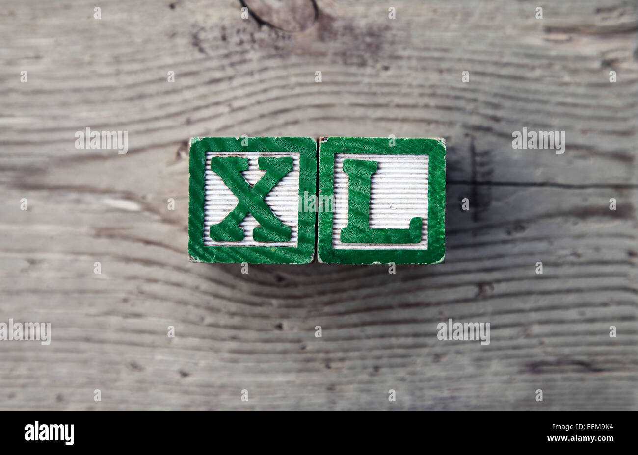 It's a photo top view of wood blocks or wood cubes combined together to create the Acronym XL for extra Large Stock Photo