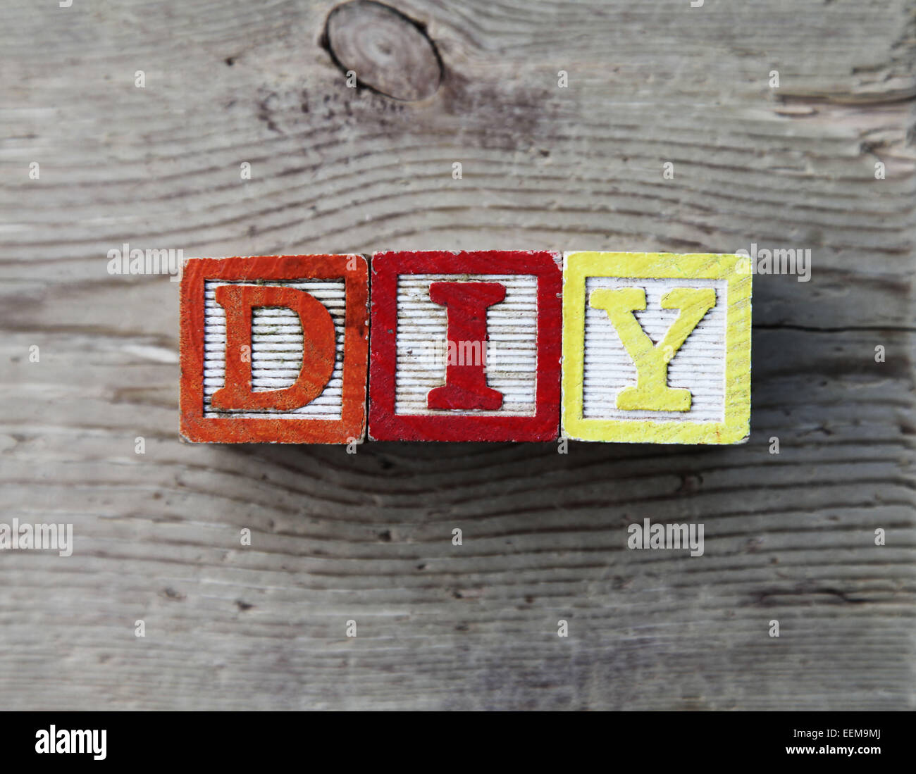 It's a photo top view of wood blocks or wood cubes combined together to create the acronym DIY for Do It Yourself Stock Photo