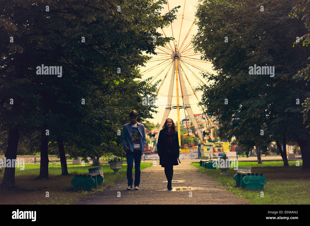 Caucasian couple walking on path in park Stock Photo