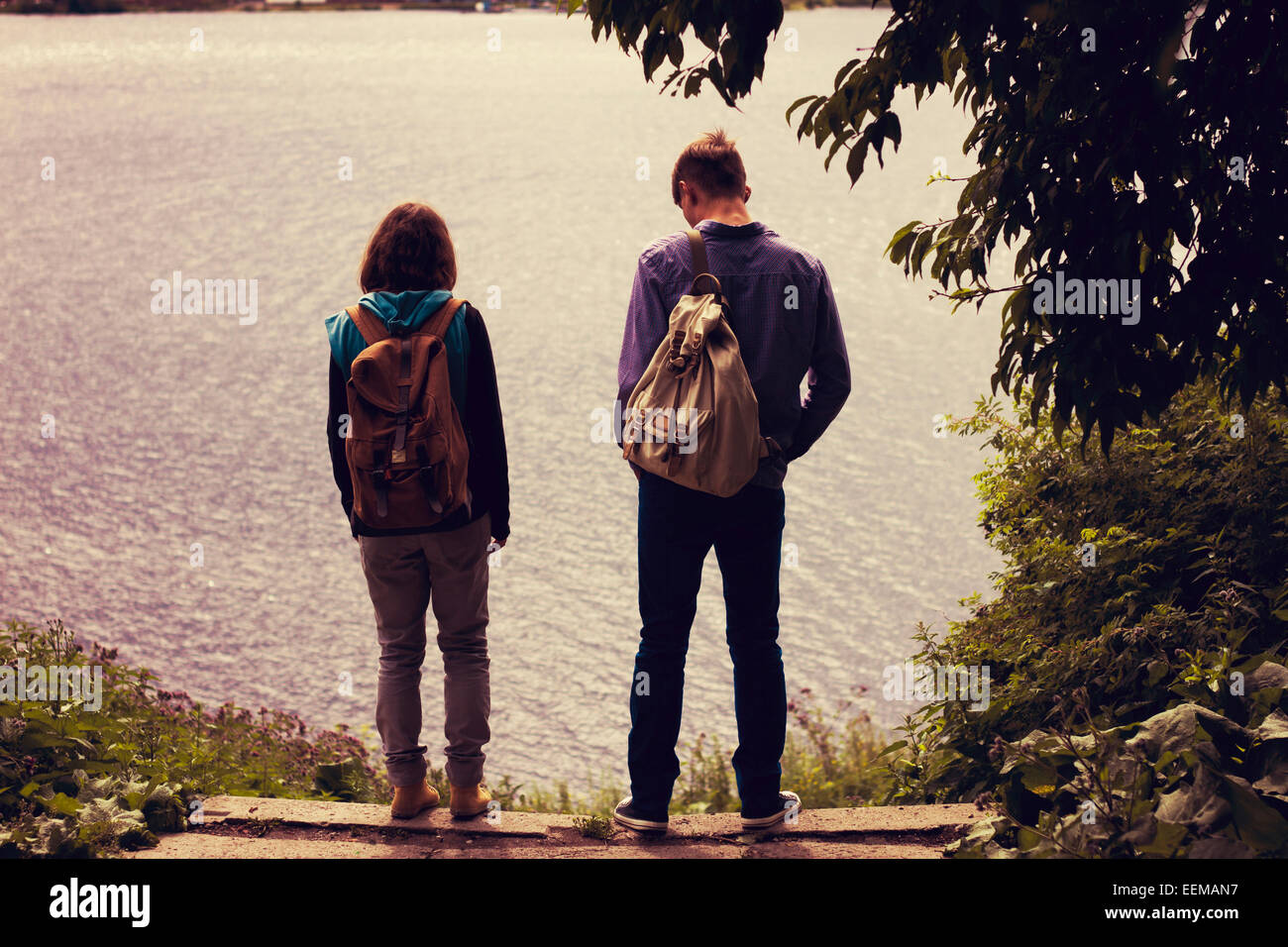 Caucasian couple standing near lake Stock Photo