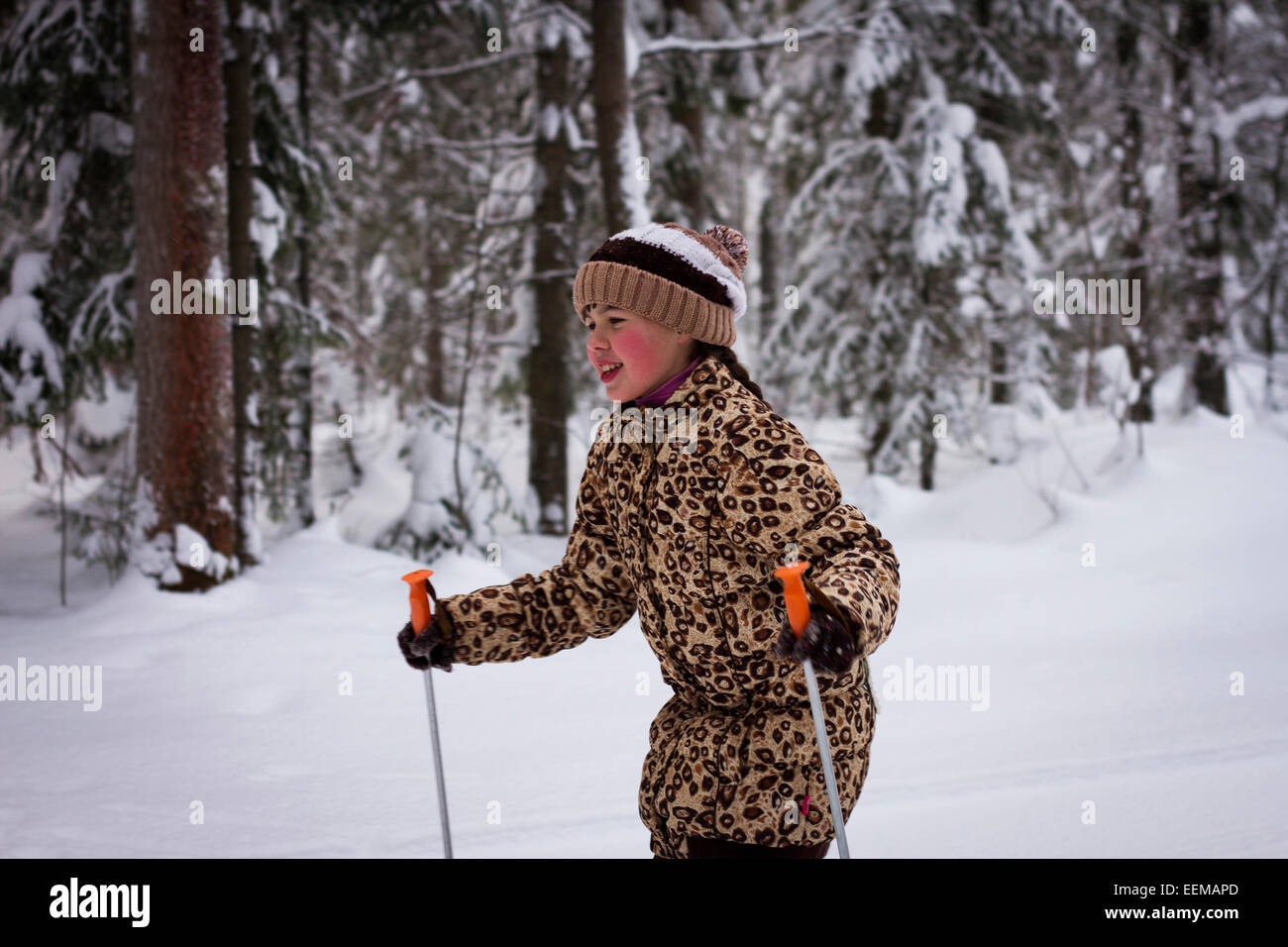 Caucasian girl cross-country skiing in forest Stock Photo