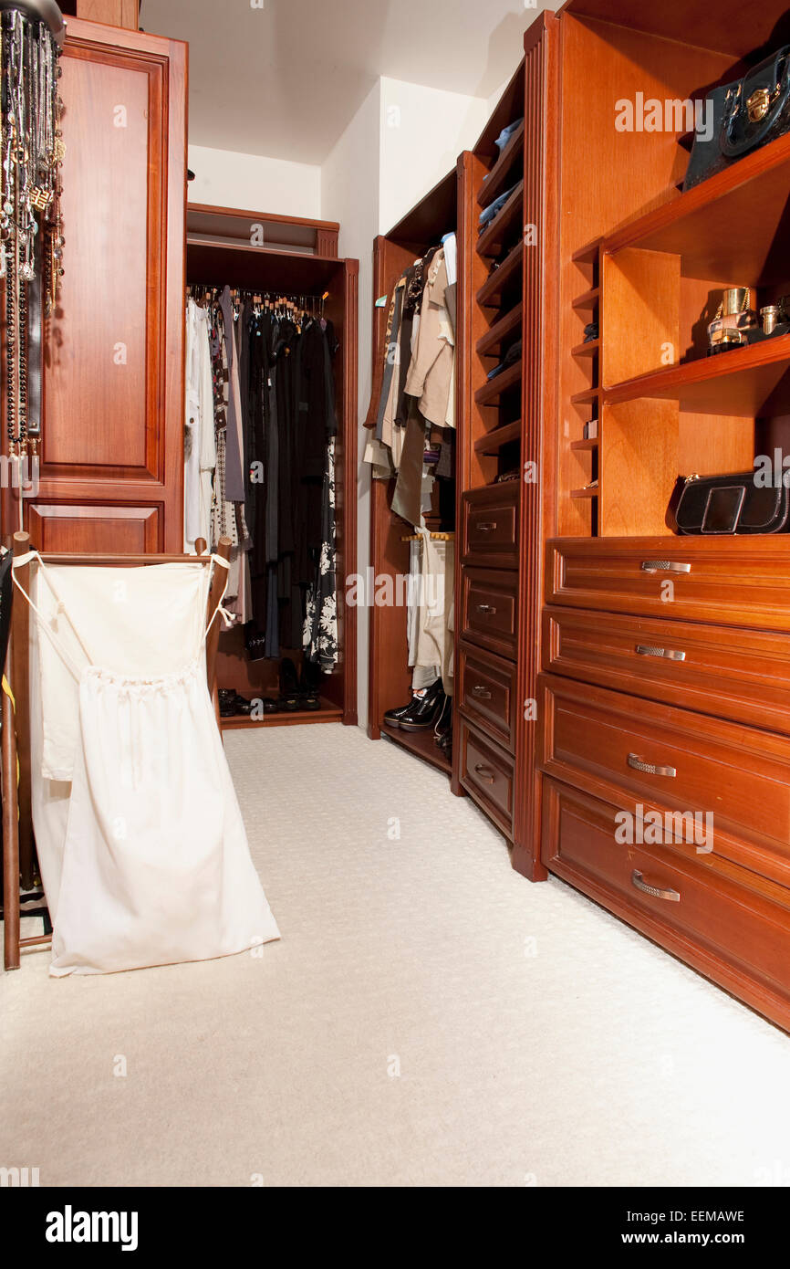 Shelves and hanging clothes in walkin closet Stock Photo Alamy