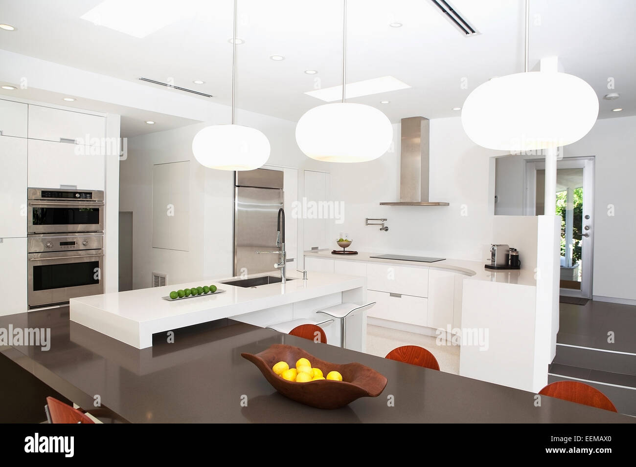 Table, countertops and light fixtures in modern kitchen Stock Photo