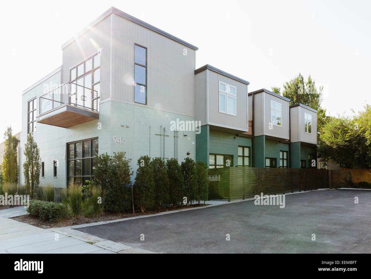 Modern condo building and parking lot Stock Photo