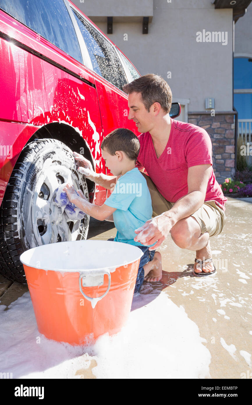 Caucasian father and son washing car in driveway Stock Photo Alamy