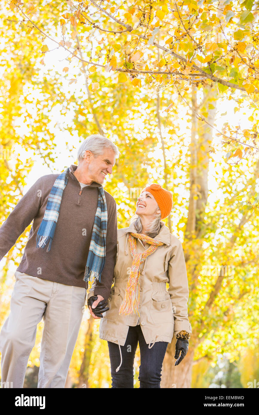 Older Caucasian couple walking under autumn trees Stock Photo - Alamy
