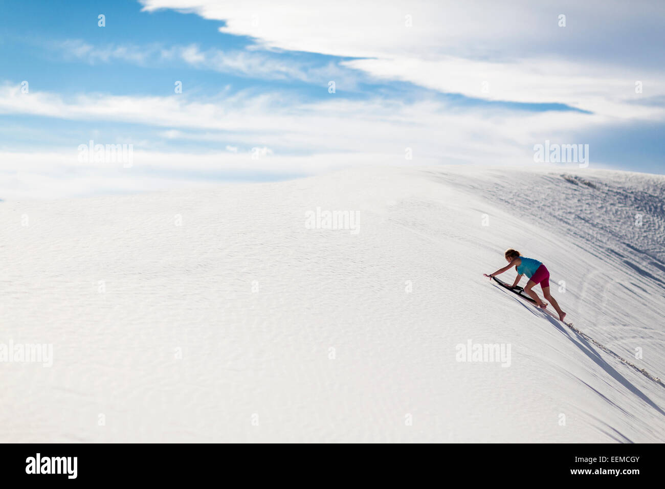 Caucasian girl climbing sand dune Stock Photo - Alamy