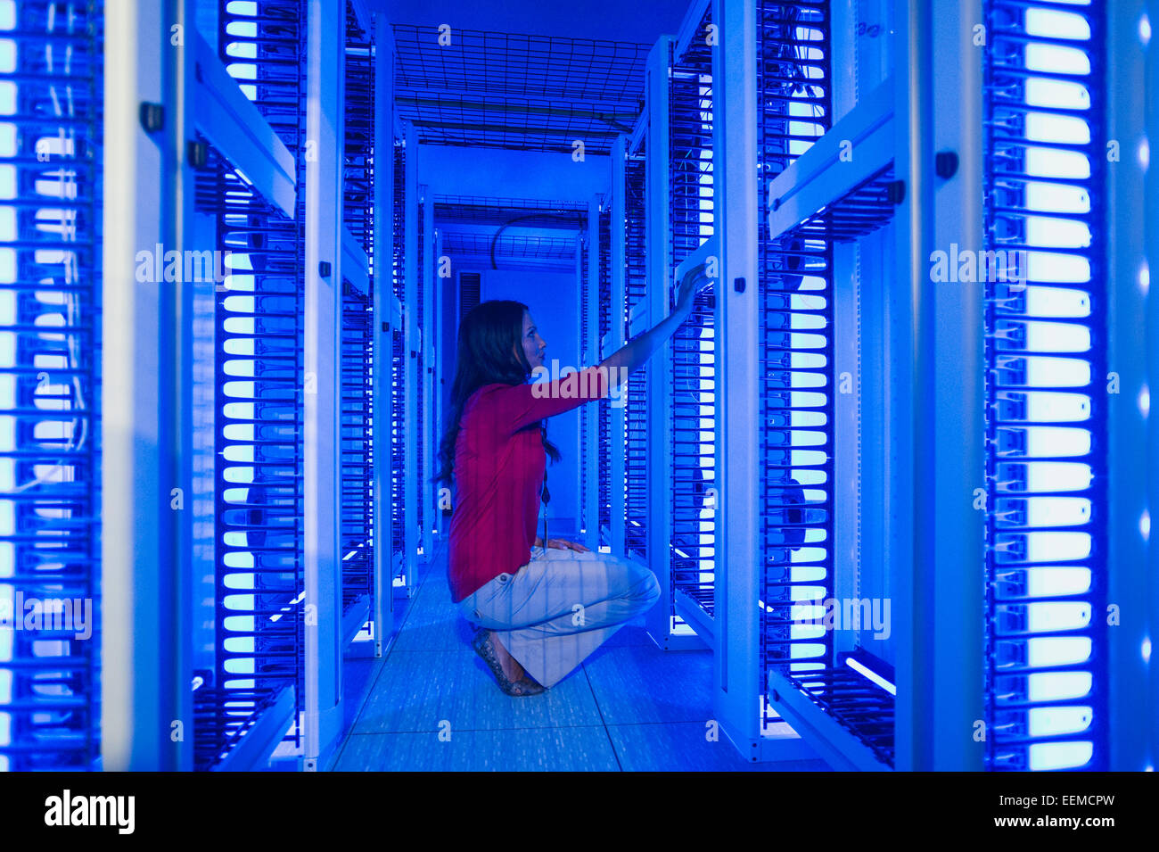 Caucasian businesswoman working in server room Stock Photo