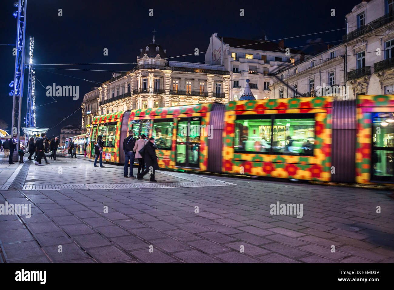 Tram passing at night at the Place de la Comedie, Montpellier, France Stock Photo
