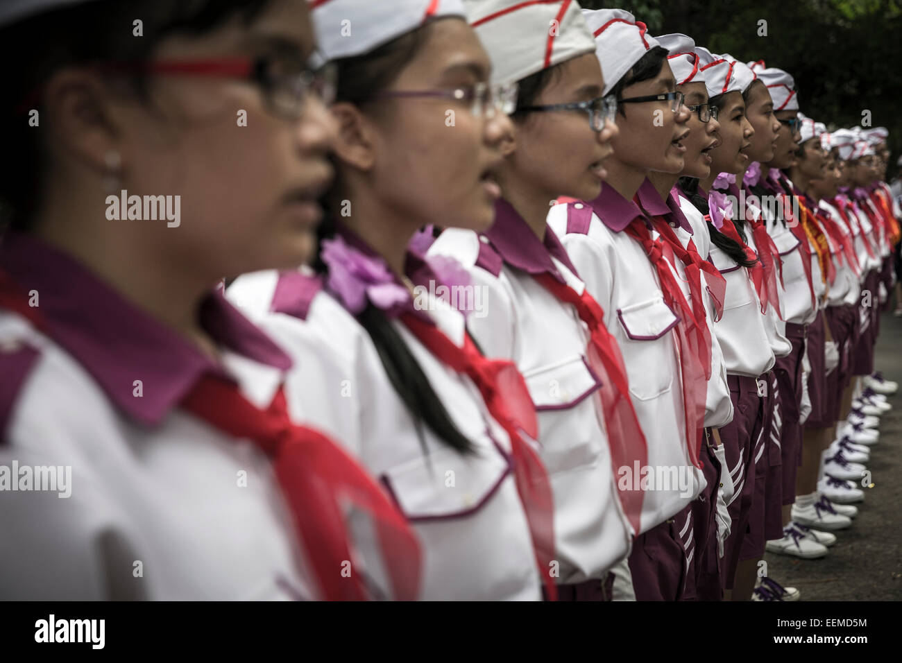A formation of children from a school in the capital sing the hymn of Vietnam. Stock Photo