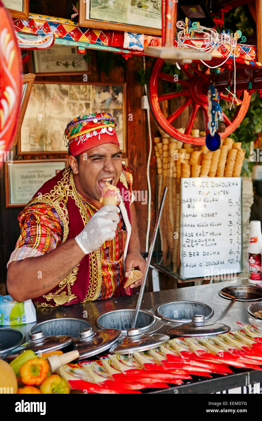 Turkish ice cream (dondurma) street vendor dressed in a traditional costume advertising his product. Sirince village, Izmir Province, Turkey. Stock Photo