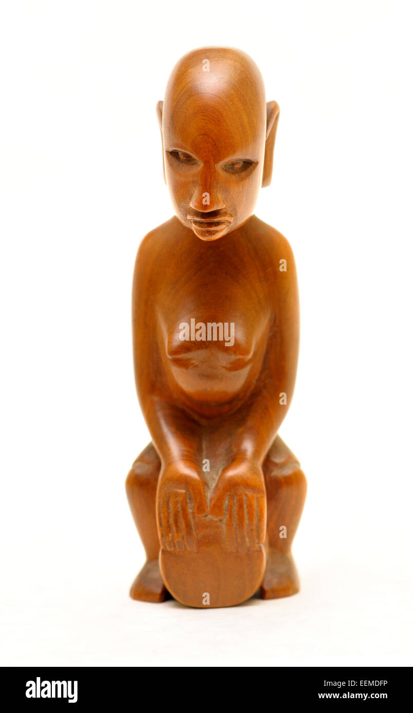 African carved wooden figure of a woman playing a drum (Kenya: 1950s) Stock Photo