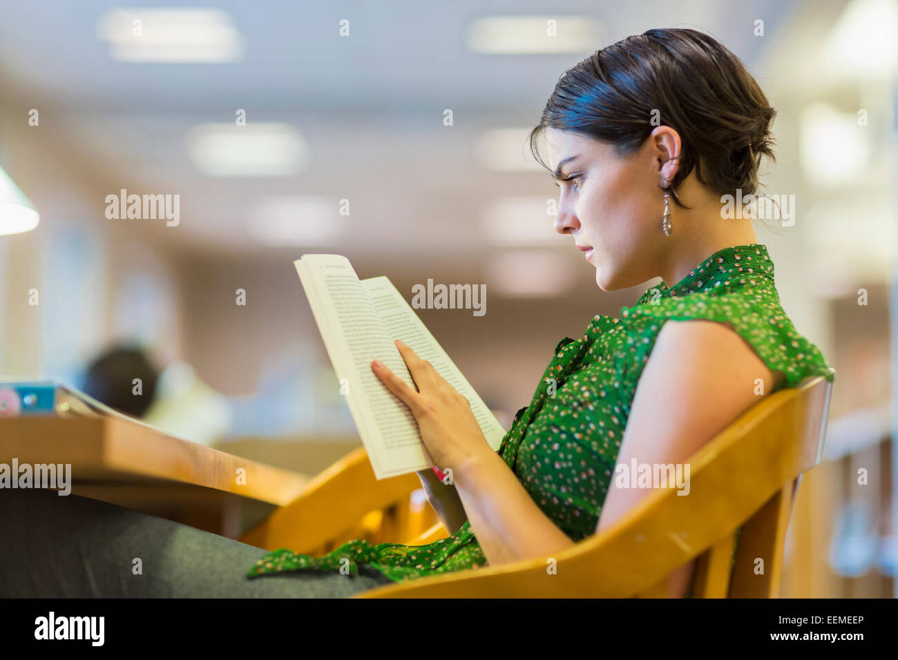 Mixed race student studying in library Stock Photo