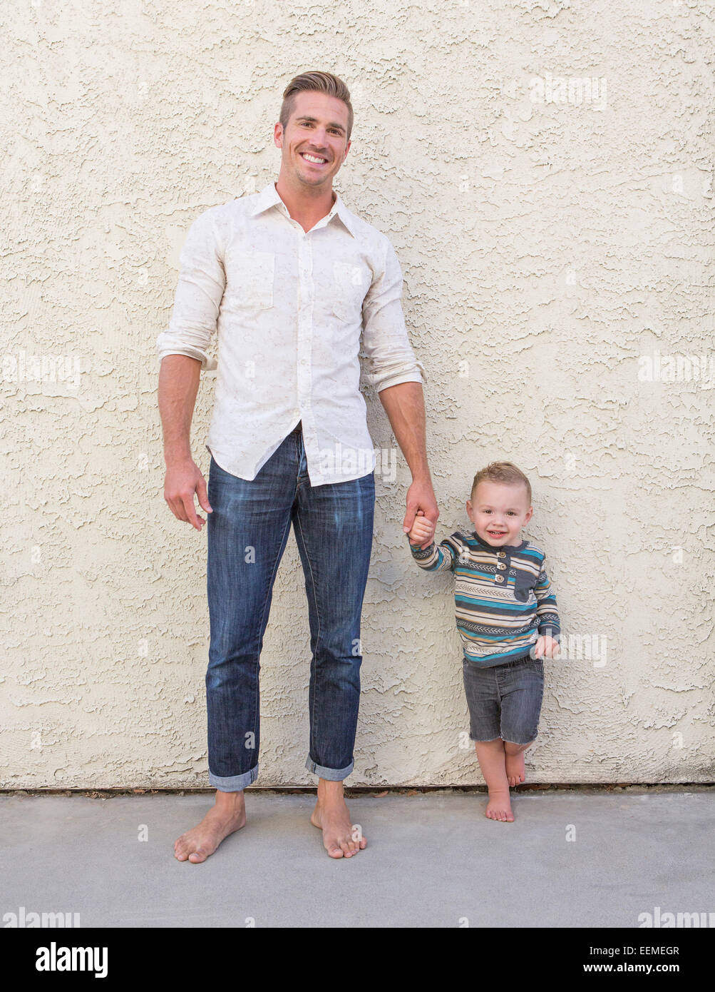 Two boys holding hands hi-res stock photography and images - Alamy