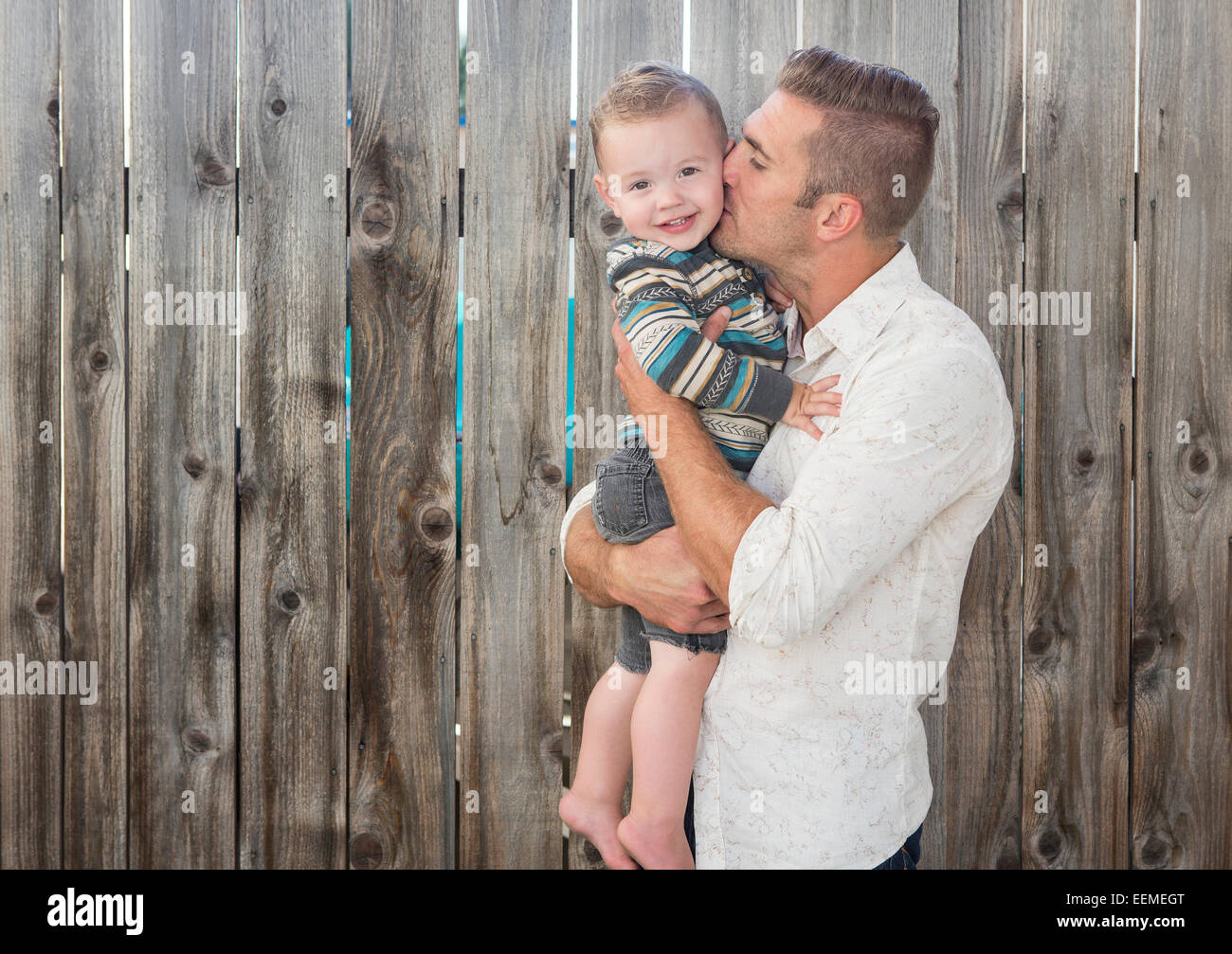 Caucasian father kissing son outdoors Stock Photo