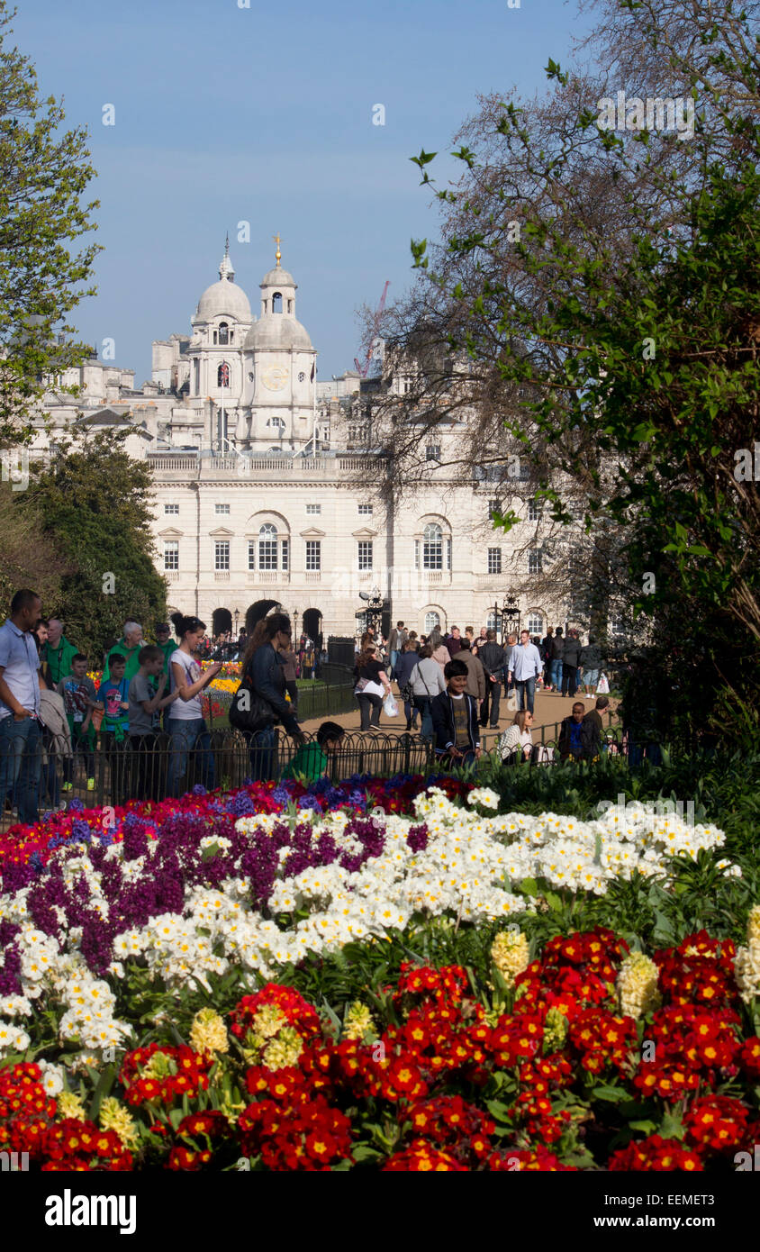 St James's Park flower beds with tulips in spring springtime looking towards Horseguards Parade with people walking by Westminst Stock Photo