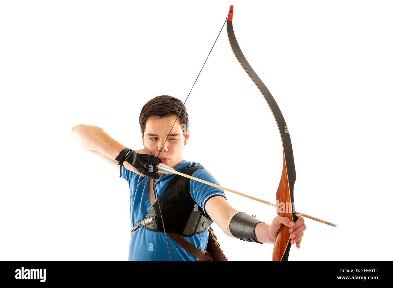 Boy with blue shirt aiming with bow and arrow Stock Photo