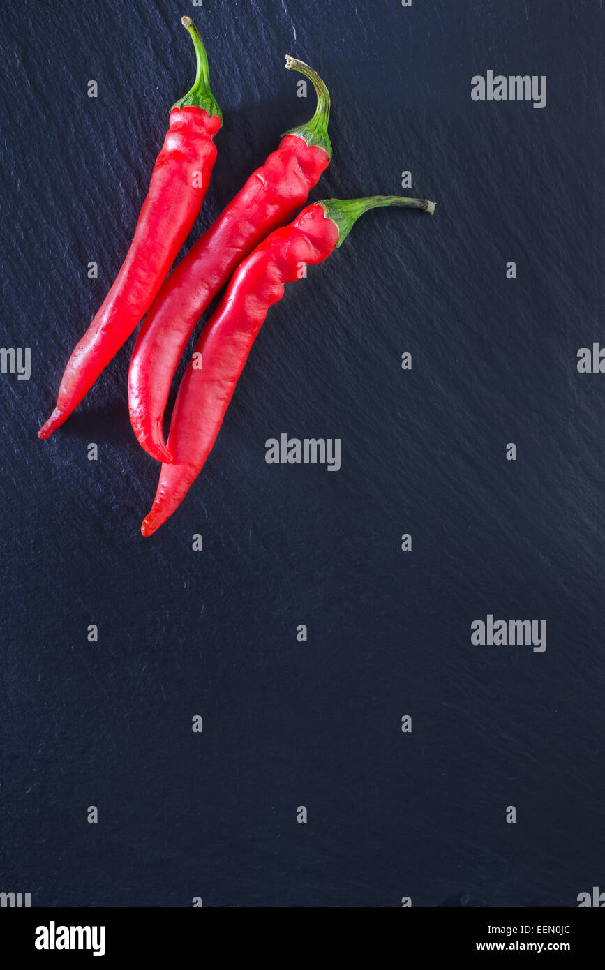 red hot chilli peppers on the black table Stock Photo - Alamy
