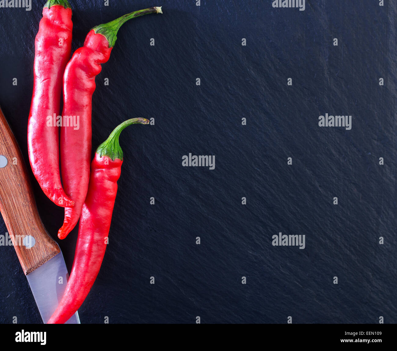 red hot chilli peppers on the black table Stock Photo - Alamy