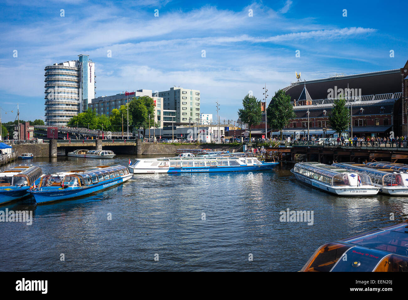 Amsterdam, touristic boats in the canal close the Central Station Stock Photo