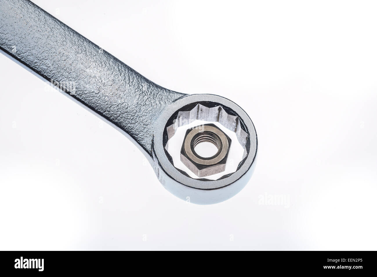 Wrong sized wrench for hex nut mismatch on white background Stock Photo