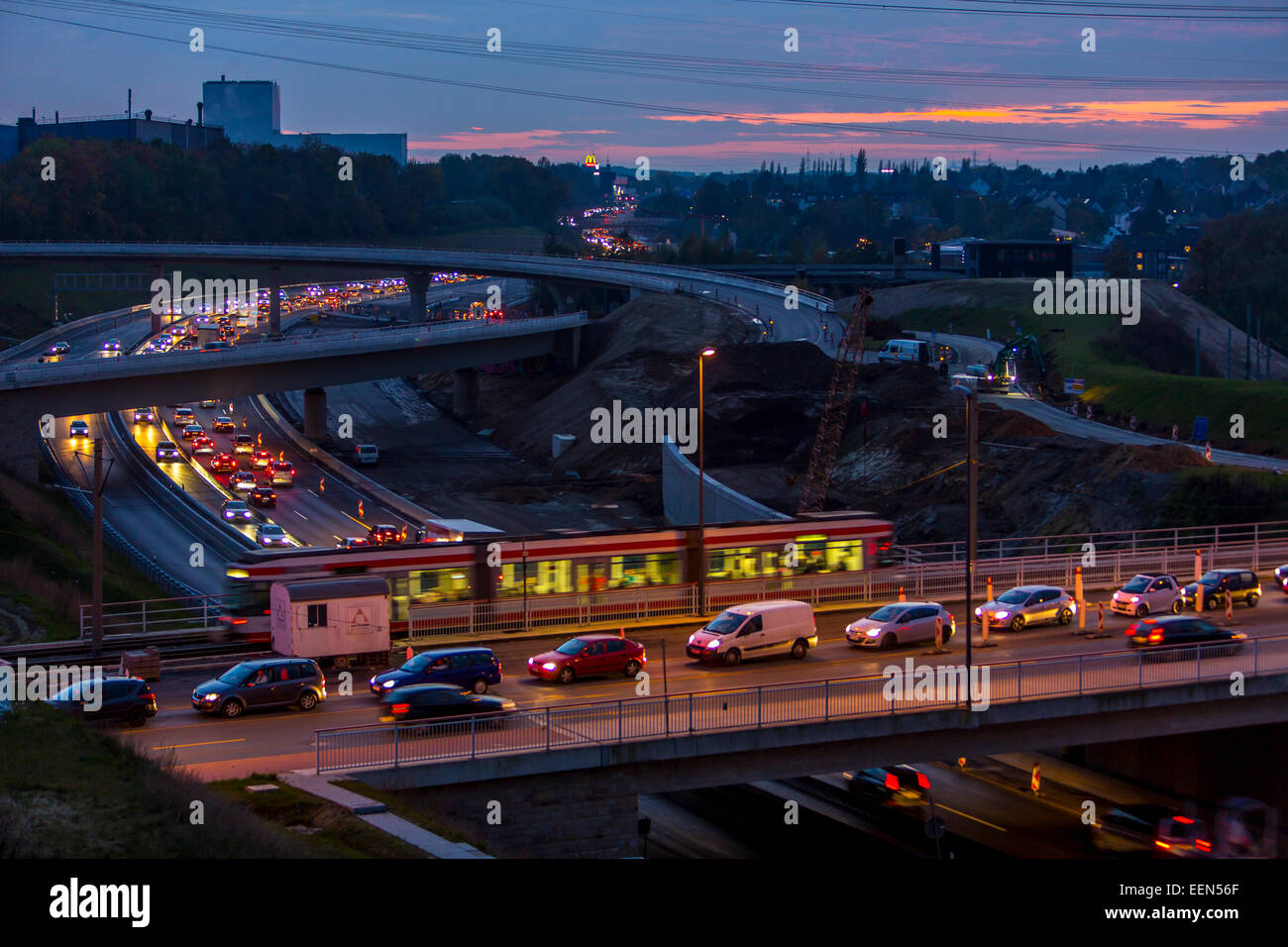 Rush hour, on A40 motorway, Autobahn, at 'West-Kreuz' - intersection west, at dusk, Bochum, Germany Stock Photo