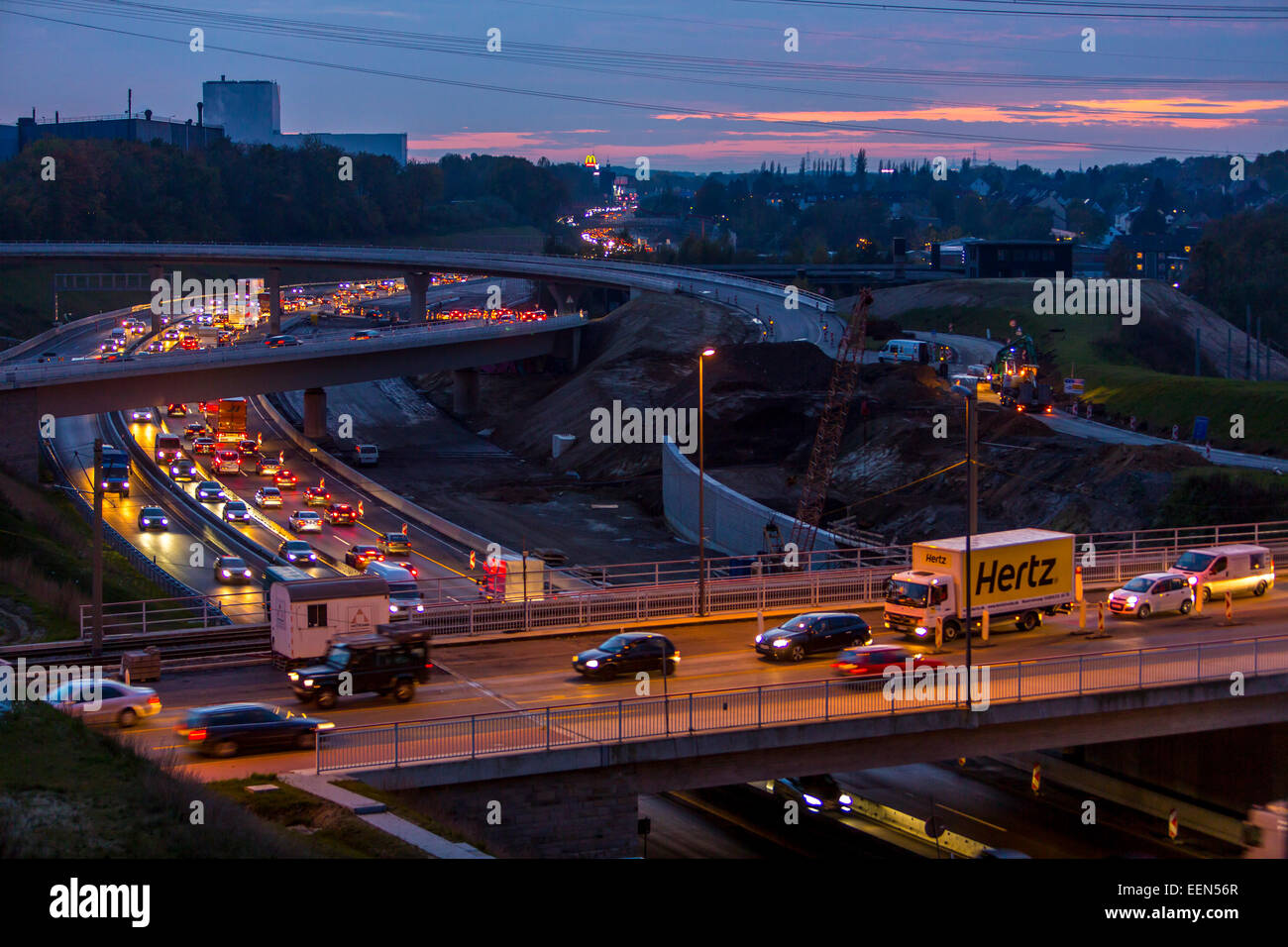 Rush hour, on A40 motorway, Autobahn, at 'West-Kreuz' - intersection west, at dusk, Bochum, Germany Stock Photo