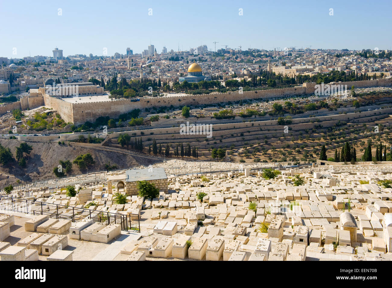 Old jewish graves on the mount of olives in Jerusalem, with on the back the temple mount with the dome of the rock Stock Photo