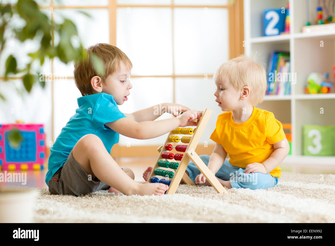 children boys playing with abacus Stock Photo