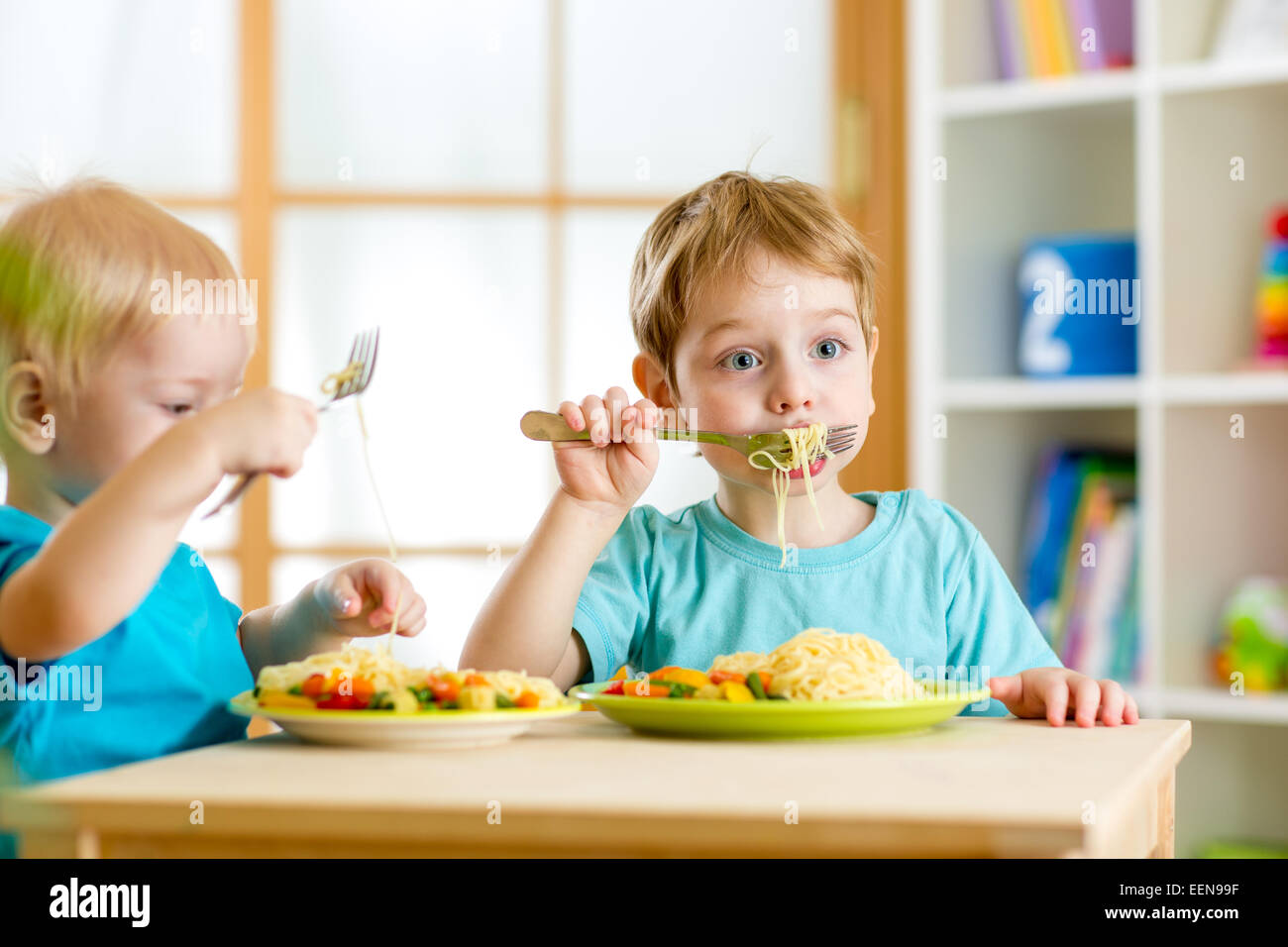 children eating in kindergarten Stock Photo