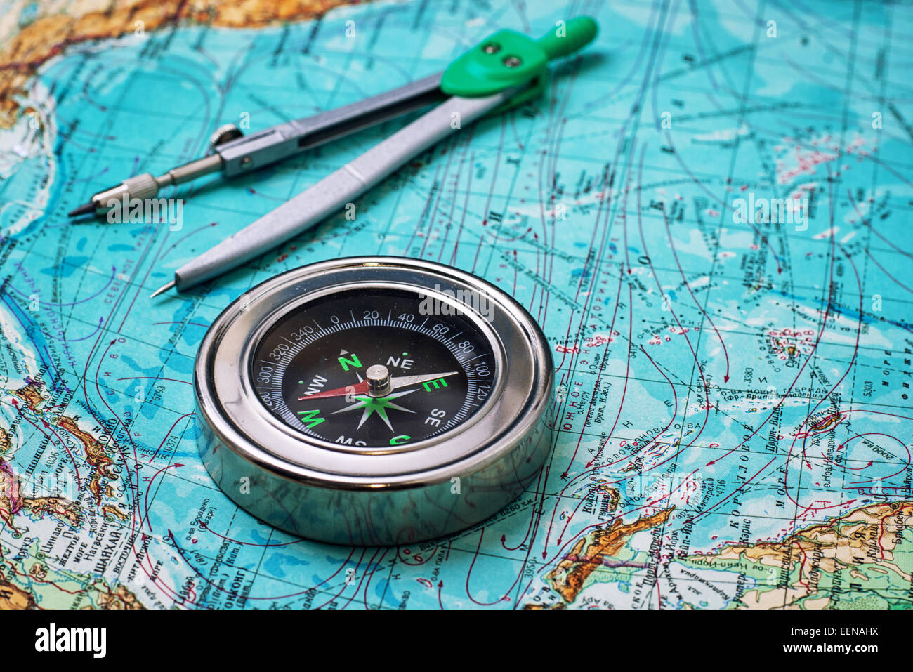 outdated compass sailor on a topographic map Stock Photo
