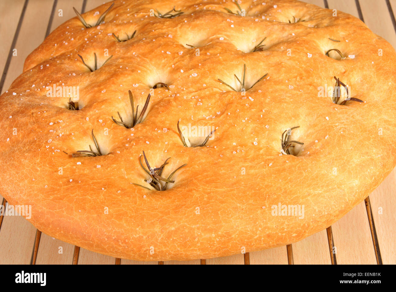 Freshly baked foccacia bread with rosemary on a cooling rack Stock Photo