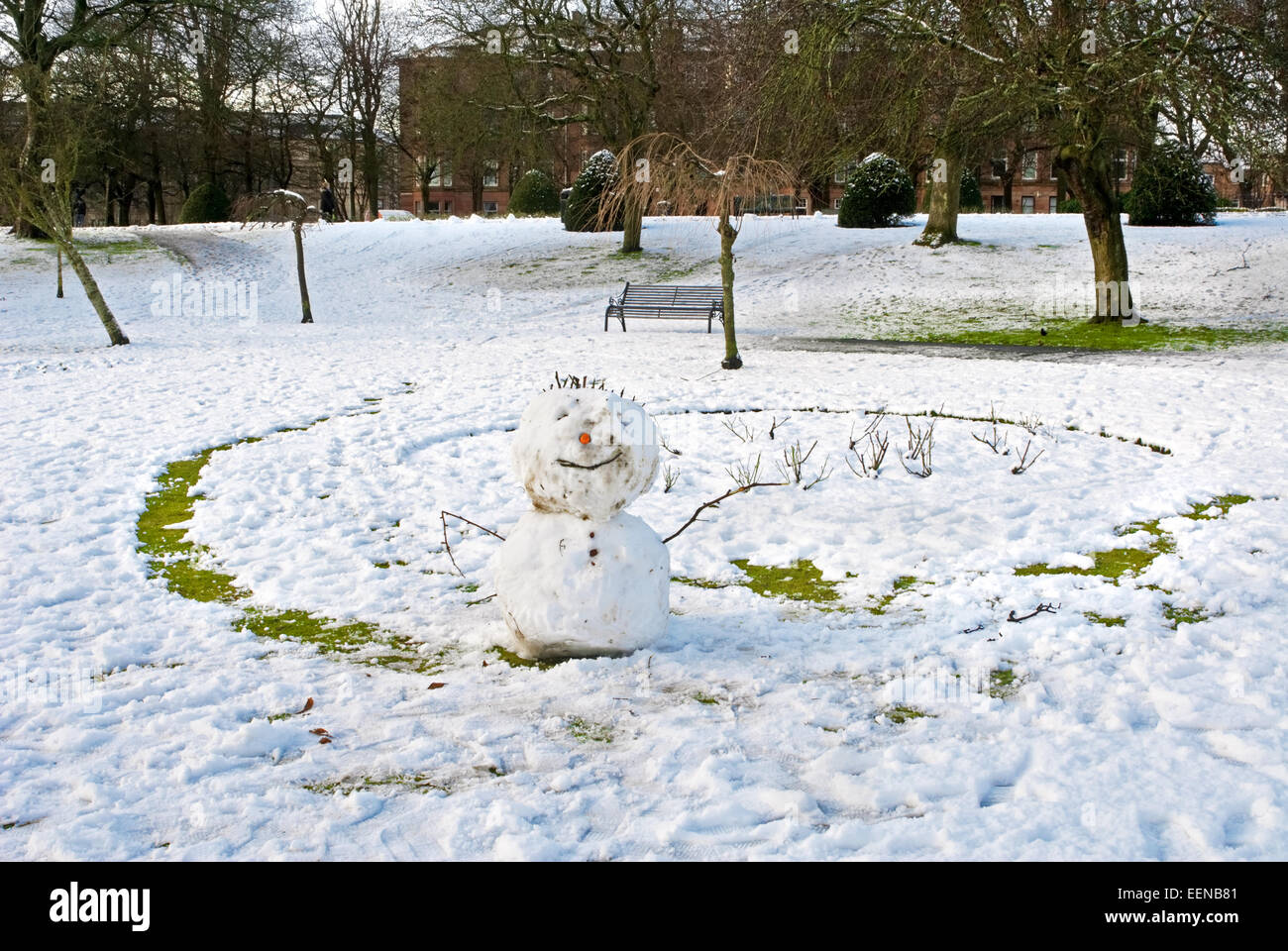 Snowman in the park in winter time Stock Photo