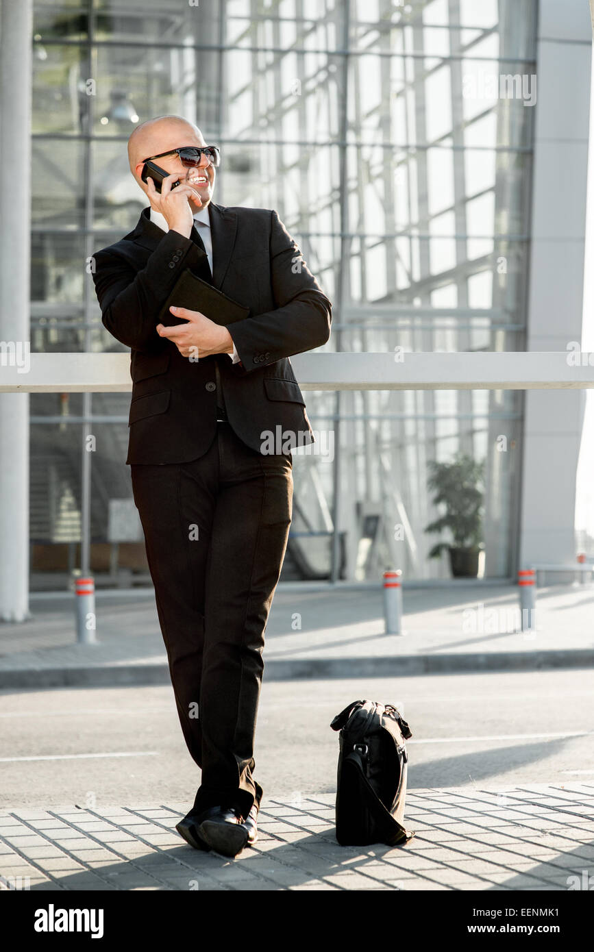 Businessman or banker working outside the airport or contemporary building Stock Photo